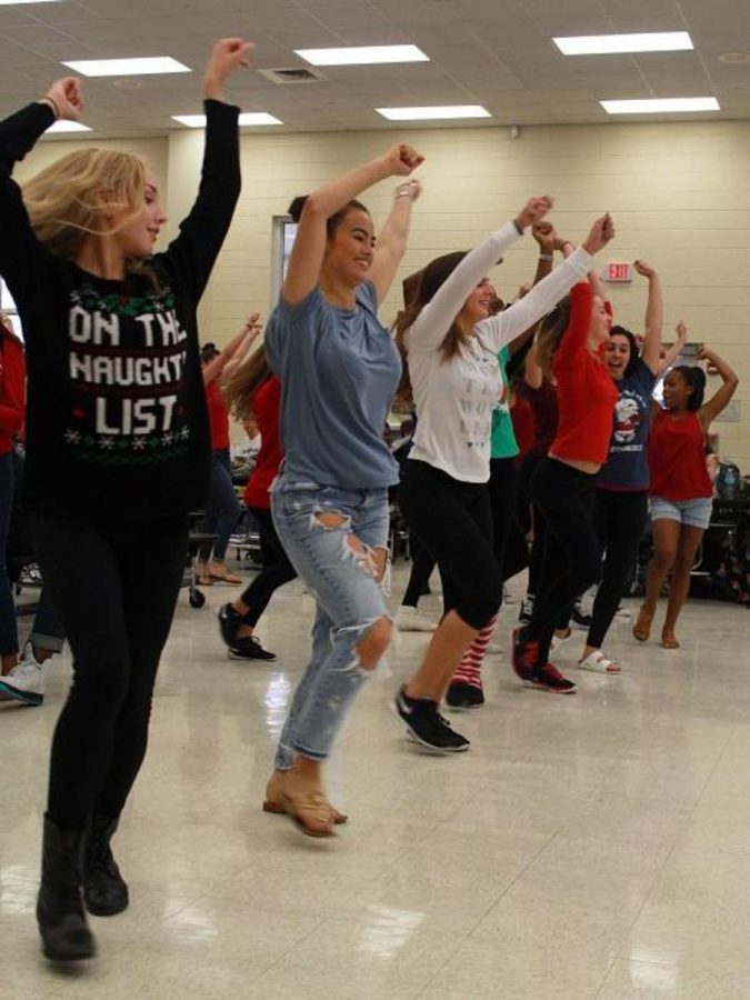 Dance seniors Morgan Aumick (L-R), Maia Kaimakliotis, Katia Lago, Delaney Holdt, Olivia Nell and dance junior Reche Nelson perform in a Christmas flash mob. The surprise dance took place in the cafeteria and featured songs such as All I Want For Christmas Is You and Feliz Navidad.