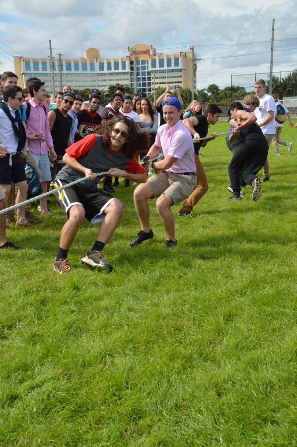 Straining in effort, visual sophomore Dalton Nellegar (left) and strings sophomore Dillon McCormick compete in tug-of-war. The sophomore class, in an upset, ultimately emerged victorious in the event.