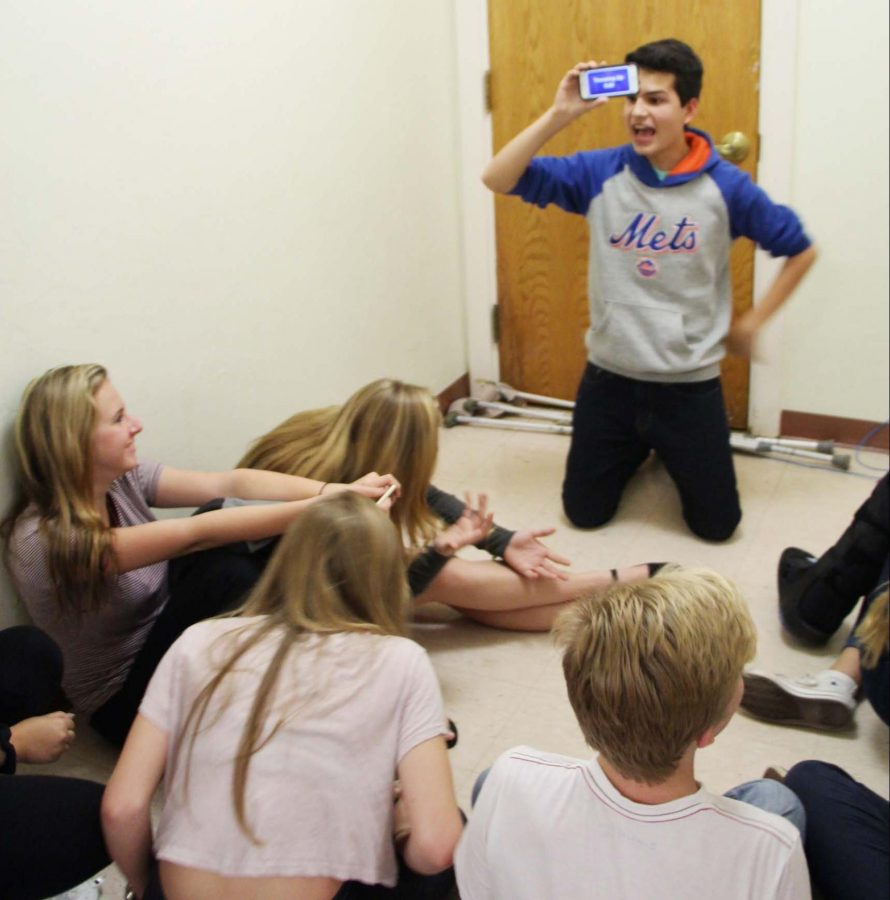 Communications freshman Michael Bole plays games with friends as they wait for the end of a tornado warning on Jan. 15.