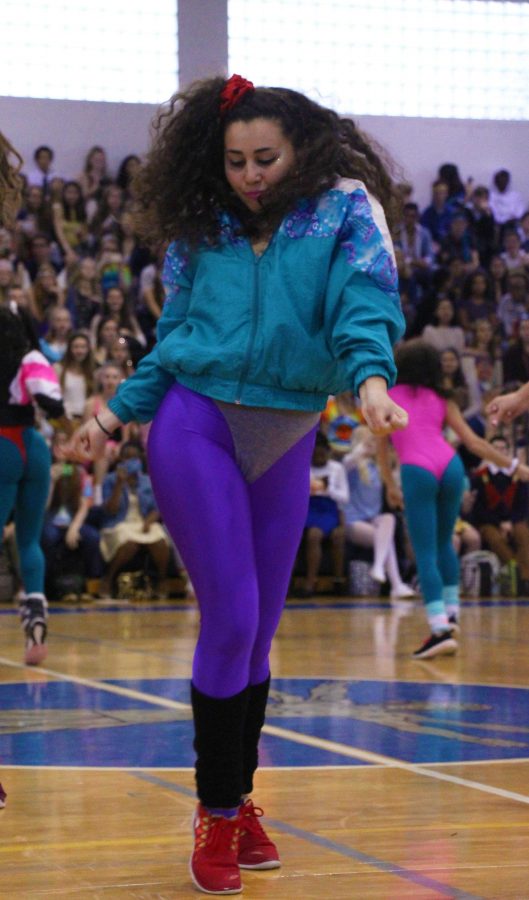 Dance senior Olivia Izenwasser gets into the 80s spirit during the seniors Generation Dance on Jan. 27.