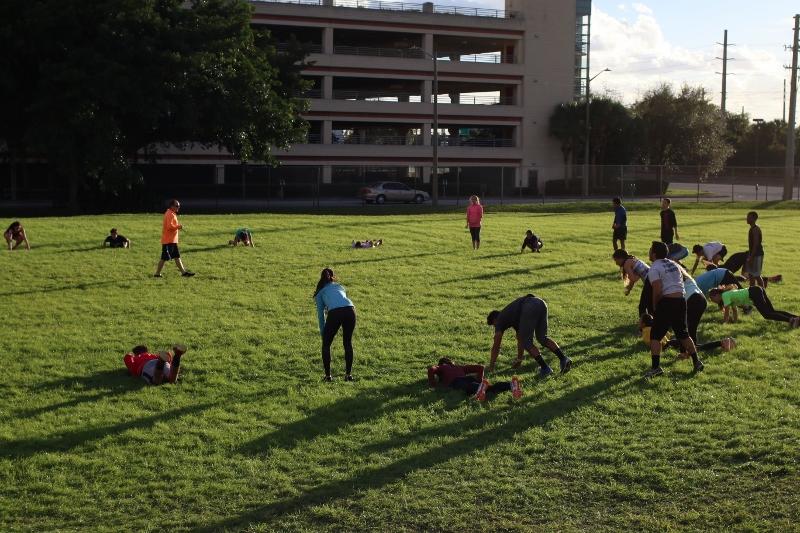 The Dreyfoos track and field team warms up with an exercise called burpees. The team has been conditioning since Jan. 12. Its a lot more intense than last year, vocal senior Jacob Crossey said. We do a lot of strength exercises more than running in practice.