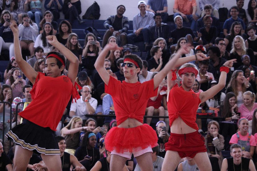 Communications junior Daniel Montoya (L-R), communications junior Daniel Kaufman, and visual junior Bjorn Corning perform in the junior Powderpuff cheer routine.