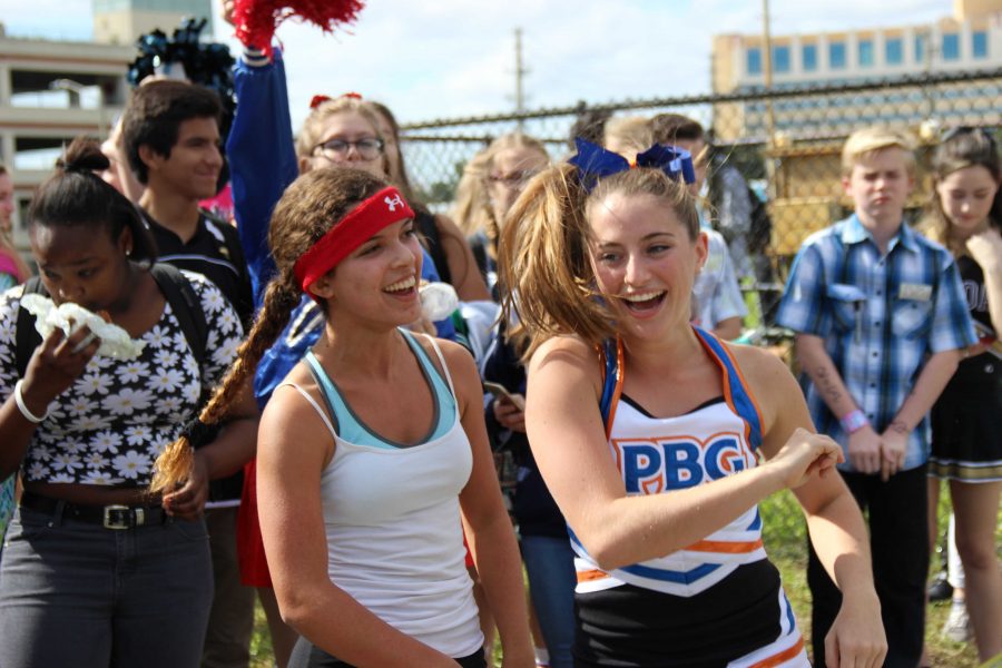 Strings junior Sarah King (left) and dance junior Jordan Wohl laugh in celebration after winning Human Hungry, Hungry Hippos, a new addition to Spirit Week Field events.