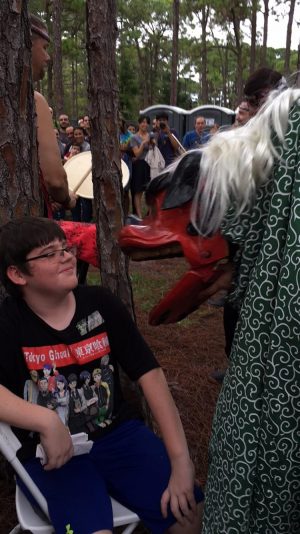 Communications junior Megan Horan’s younger brother, Sean Horan, has an encounter with the New Year’s lion at the mochi pounding ceremony.