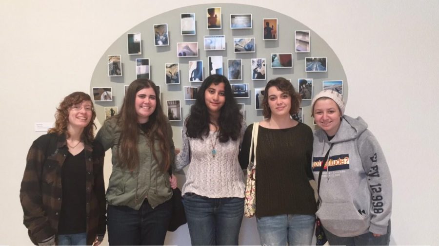 Communications juniors Brianna Steidle, Megan Horan, Uma Raja, Samantha Marshall, and Kayla Kirschenbaum pose in front of artwork at the FAU faculty gallery. 
