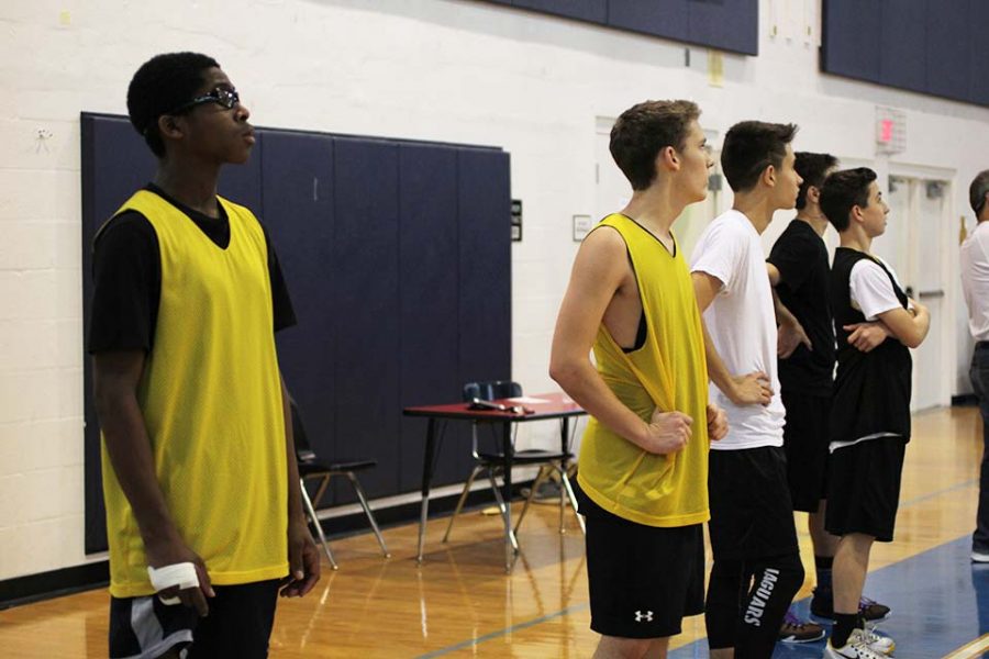 (L-R) Visual freshman Lance Carter, communications junior Riley OConnor, visual freshman Thomas Haynes, and visual sophomore Matthew George stand on the sidelines during practice, as they watch their team mates participate in a conditioning drill. 