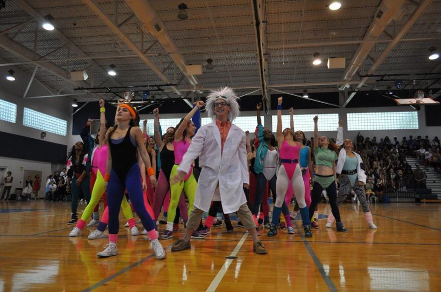 Dance seniors Savannah Alberty (L-R) and Paul Rispoli pose at the end of their 80s generation dance with Rispoli dressed up as Doc Brown from Back to the Future.  