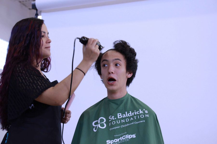 Theatre+sophomore+Evan+Kwon+shaves+his+head+to+raise+awareness+for+childhood+cancer+at+St.Baldricks+shaving+and+fundraising+event.+The+club+raised+over+%247%2C500+for+kids+battling+cancer.+