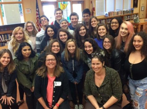 Author Pam Houston (front left) poses with the junior and senior creative writing classes in the media center after instructing a writing workshop.