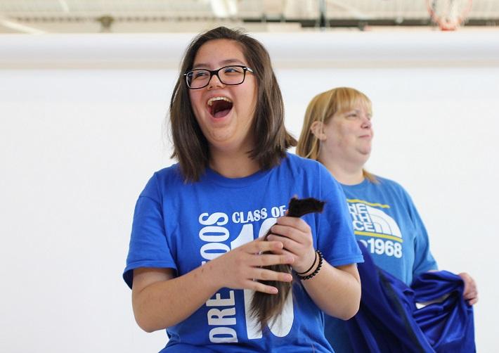 Piano freshman Annemarie Gerlach smiles widely after cutting off multiple inches for St. Baldricks.