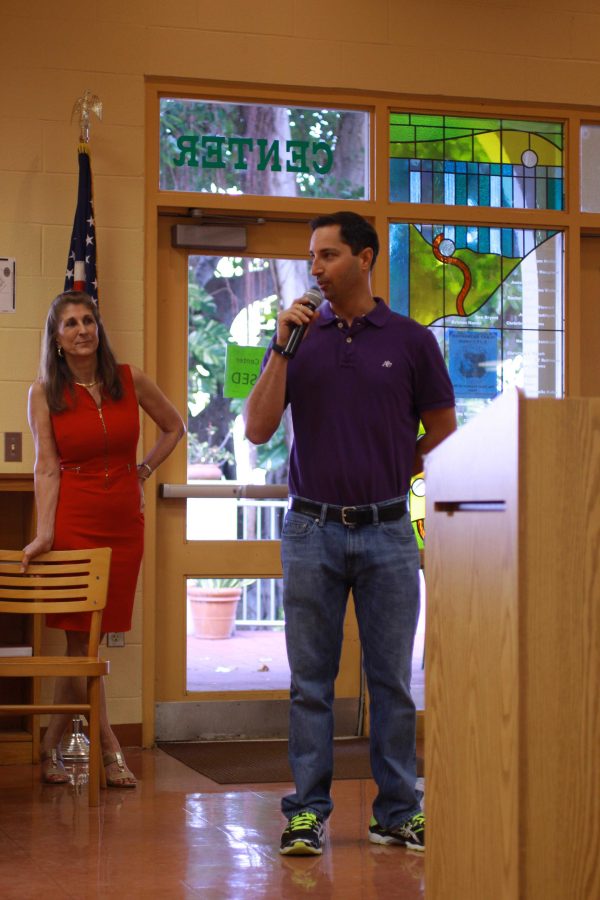 Science dean Stephen Anand (right) stands beside Principal Susan Atherley and speaks at the faculty meeting on March 15 celebrating his Teacher of the Year Award win. 