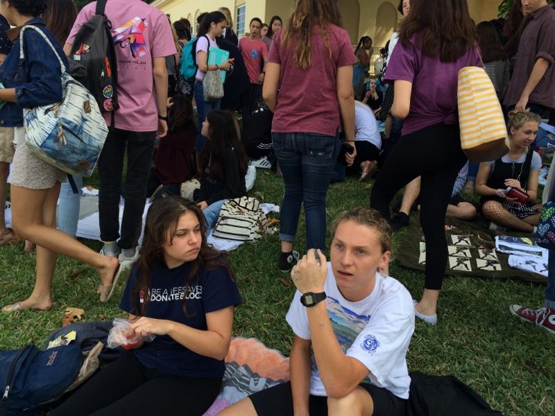 Digital media junior Sara Green sits with digital senior Austin Wilk at the Freshman

Hill art sale on Friday, March 4. Wilk sold stickers printed with his own design for 50 cents each.