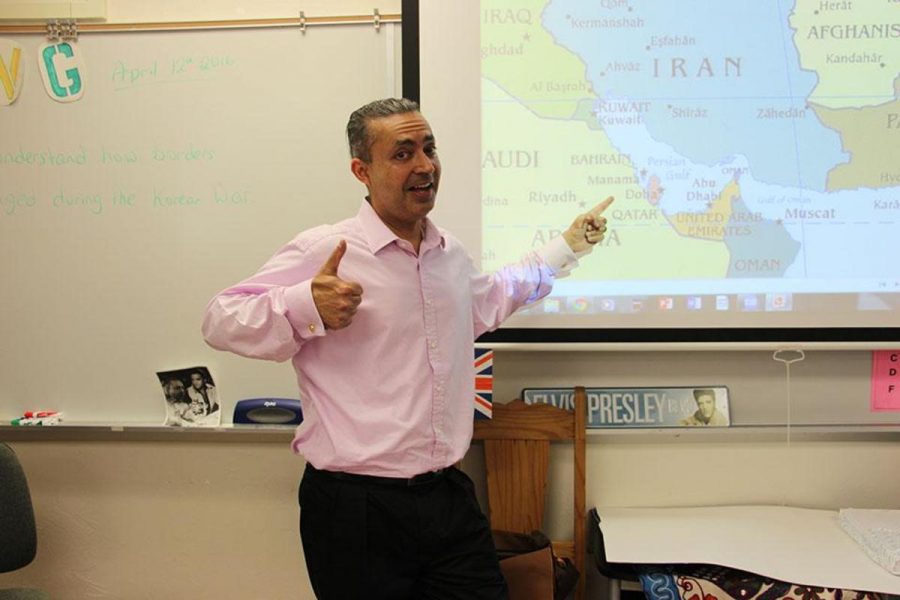 Social studies teacher Dr. Gary Bicker points to his soon-to-be home, Bahrain, on a map (the red country). Over the summer, he is moving to Bahrain, where he was offered a position to teach eighth grade social studies at an international school.