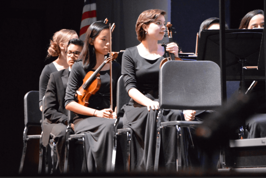 (Front to Back:) Strings senior Kasia Leavitt, strings freshman Seoyoung Kwon, and strings sophomore Nicholas Abrahams play “Hebrides Overture” at the last Philharmonic Orchestra of the year.