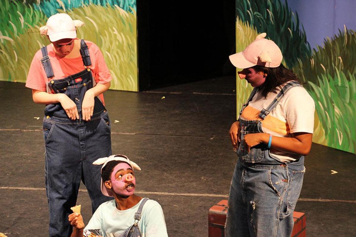 Theater freshman Danielle Goldfire (L-R), junior Michael Joseph, and freshman Mikayla McInnis play the three little pigs. They disclose that they plan to build three houses: one of straw, one of sticks, and one of stone.
