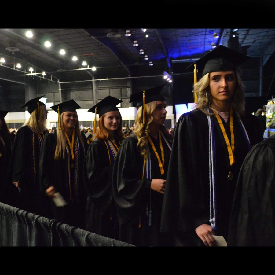 Dance seniors Delaney Holdt (L-R), Kiandra Hering, Laura Guley, Morgan Aumick, and Lucia De-Poli get ready to walk into the graduation ceremony. 