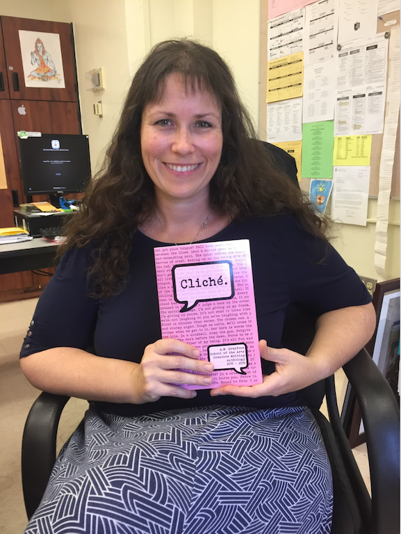English and communications teacher Brittany Rigdon holds the latest anthology published by her junior and senior creative writing classes. The theme of the book is “cliché,” and it is a collection of pieces that each student has worked on throughout the year. 