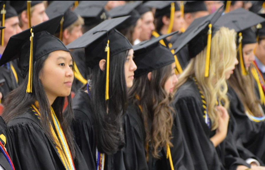 Piano senior Tiffany Chen (L-R), digital media senior Nina Marchell, piano senior Alexandra OBrien, dance senior Morgan Aumick, and digital media senior Valentina Suarez wait to receive their high school diplomas. 