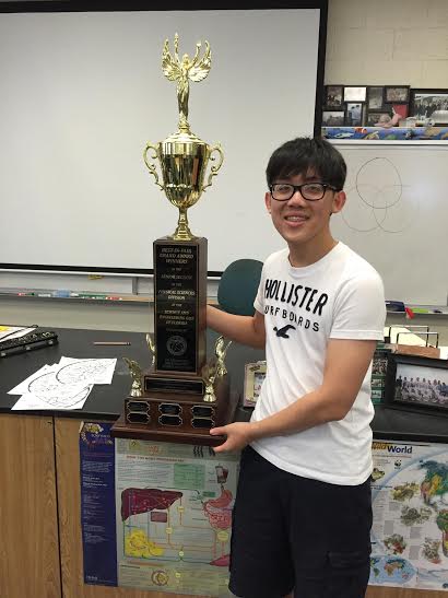 Piano junior Stefan Wan stands with the trophy he received from the Florida State Science Fair after placing first in the Environmental category.  Wan was able to advance onto the International Science and Engineering Fair held in Phoenix, Arizona on May 8-13 where he placed second in in Environmental Engineering.