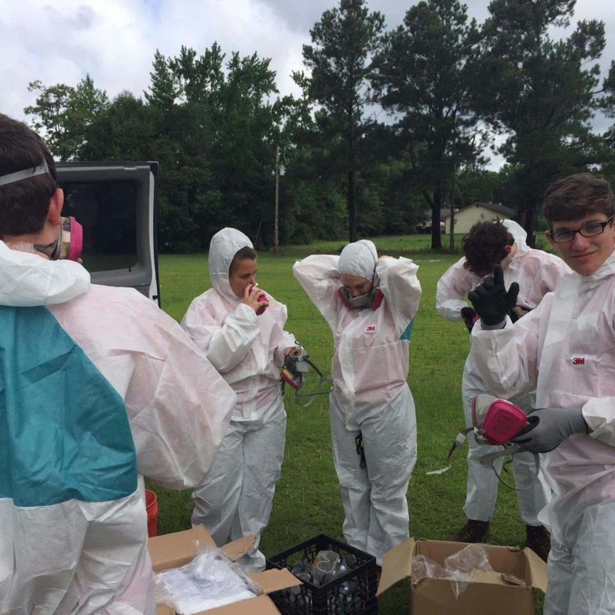 Clad in hazmat suits, goggles, and gas masks, Project Tikvah attendees went into a home in Georgetown, South Carolina to try and provide flood relief.