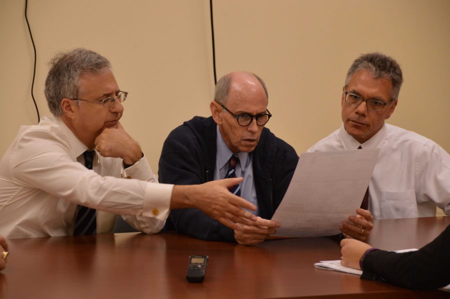 (L-R) County Commissioner Steven Abrams, Judge Leonard Hanser and Judge August Bonavita, members of the Supervisor of Elections Canvasing Board, review a rejected absentee ballot. The Canvasing Board studies each ballot and attempt to determine the intent of the voter.