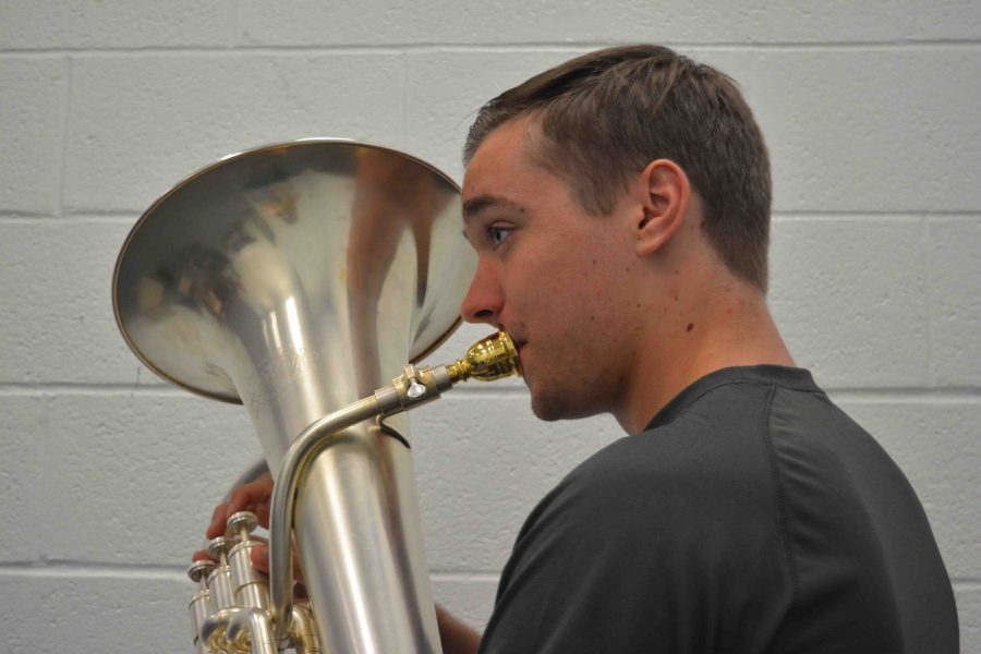 Band junior Spencer Edwards plays his euphonium in a music room during lunch. Practice makes perfect, Edwards said.