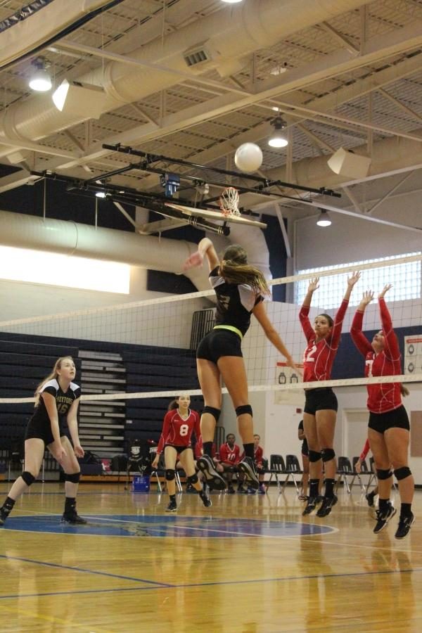 Digital senior Ali Mundan prepares for a hit as communications junior Chantel McMillan spikes the ball over the net at a game against Santaluces High School on Sept. 26.