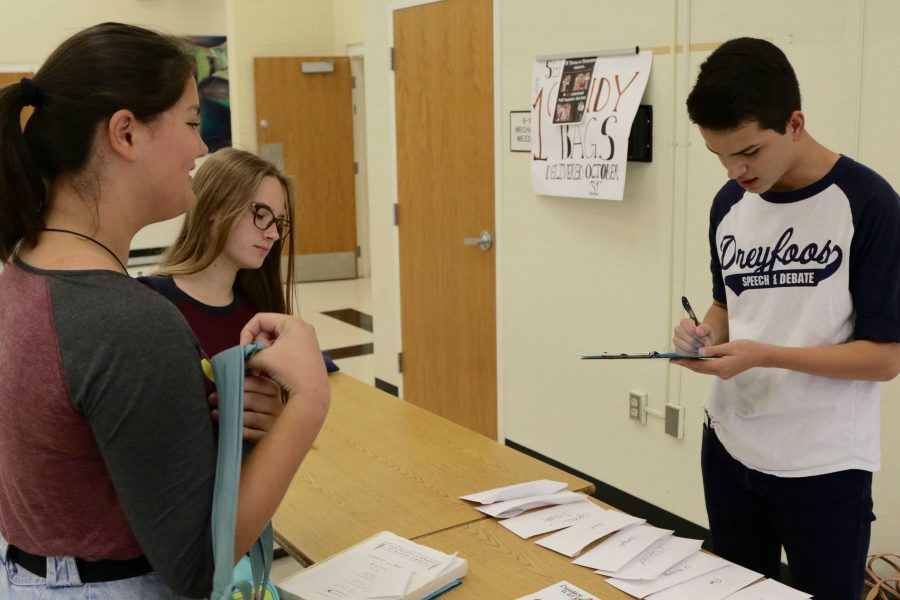 Communications sophomore Michael Bole sells a Dreyfoos piano sticker as part of a Speech and Debate fundraiser. The Speech and Debate team will be selling stickers every day at lunch in the cafeteria to raise money for their upcoming tournaments.