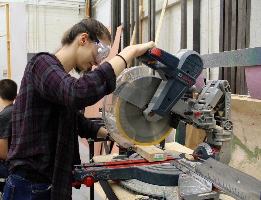 Theatre senior Isabel Block cuts a piece of wood that will be used to assemble the set for Dreyfoos latest production, The Addams Family. Addams Family is opening October 28th. Build Crew has been working hard, and were getting things done. I feel confident that well be ready for the show, Block said.