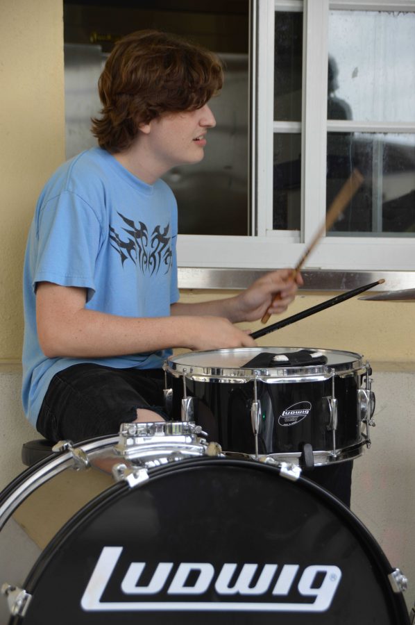 Theatre senior Ben Rothschild plays the drums as Dreyfoos' club, The Collective, performs at lunch to celebrate International Women's Day. "We decided to put on a show for the club because we love the cause. It was really fun and a great opportunity to celebrate women and get people together through music," vocal senior Makayla Forgione said. The Collective performed with various people from all majors to put on a show for students at lunch.