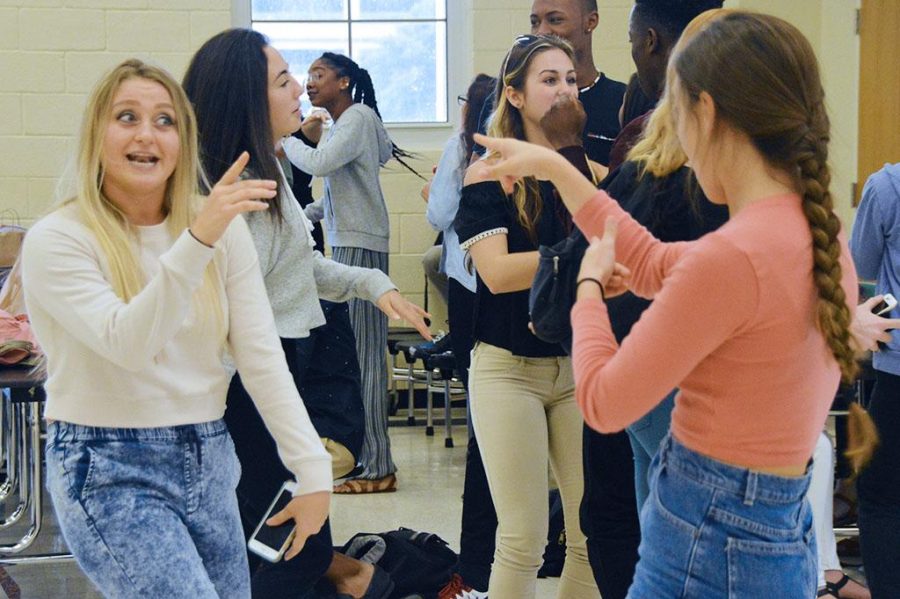 (L-R) Dance senior Miranda Capparelli and junior Madelynn Gallo dance and sing along to music at the Fun Friday event hosted in the cafeteria by SGA.