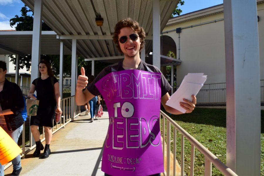 Communications sophomore Jake Kaywell hands out submission forms for Seeds Literary Magazine. They are accepting submissions through Dec. 16.