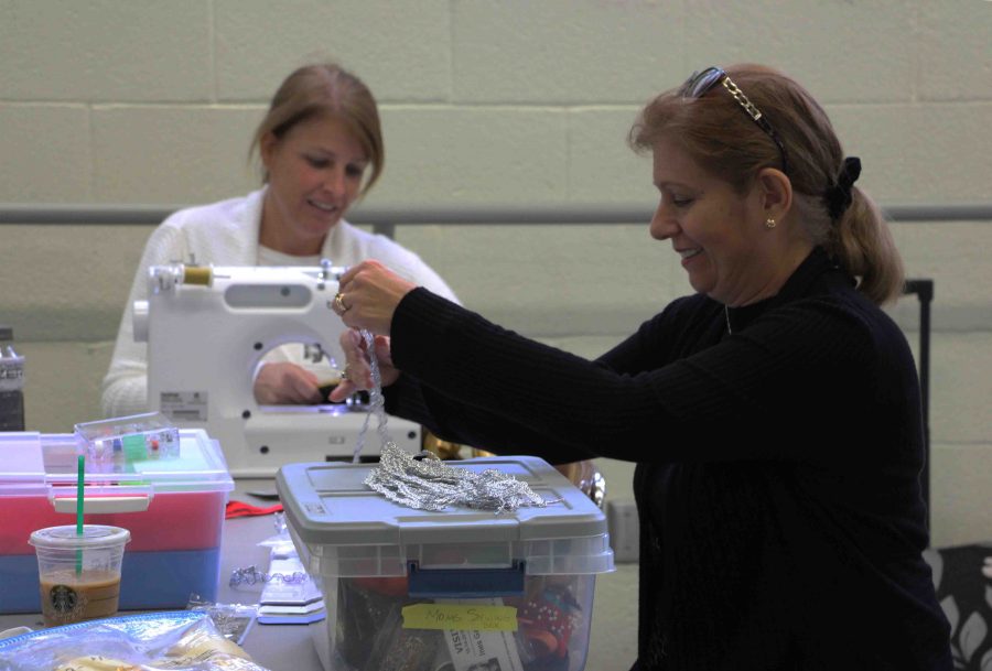 [L-R] Parent volunteers Paula Jaffe and Ines Garcia work on making costumes for the upcoming dance shows.