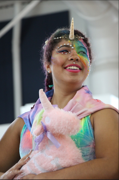 Theatre senior Sarah Joseph shows off her unicorn costume and makeup at the Fall Festival held in the gym. 