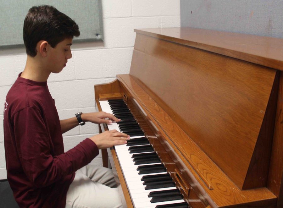 Piano sophomore Griffin Miller practices piano for Prism, which takes place Nov. 30 at the Kravis Center.