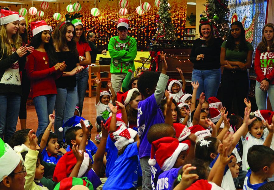 Children in attendance at A.R.T.S. Clubs annual Jefferson Jubilee excitedly raise their hands as they were greeted by Santa, who came to the event bearing gifts for each of them.