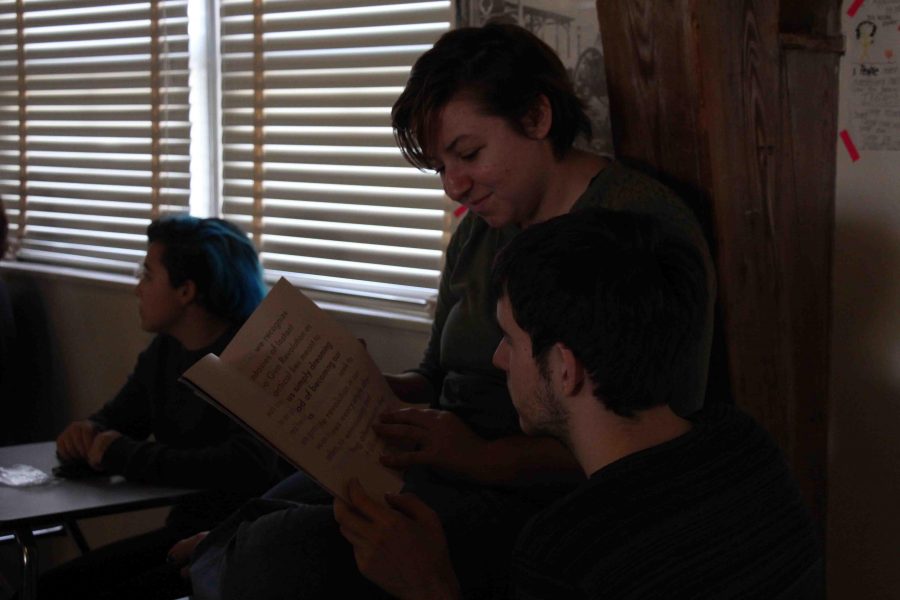 [L-R] Communications senior Kayla Kirshenbaum and theatre senior Nick Pollock admire The Bohemian, a magazine created by artist in residence Emmy Kenny and her partner CJ Riehl, in the GSA (Gender and Sexuality Alliance) meeting at lunch. The magazine had two different lifespans. The first one we started as students to bridge the gap between students and [Kansas] city. After we discovered Riot grrrl (a 1990s feminist punk movement) we reformatted the magazine to focus on social issues like gender and sexuality. We started all of this as a platform to help amplify the voices of marginalized groups.