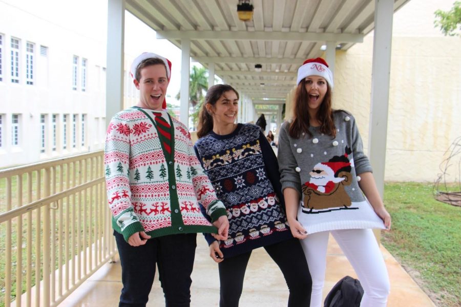 Vocal+senior+Jared+Freedland%2C+piano+senior+Christina+Harbaugh%2C+and+communications+senior+Hannah+Dunn+show+off+their+holiday+sweaters+for+Ugly+Sweater+Day.