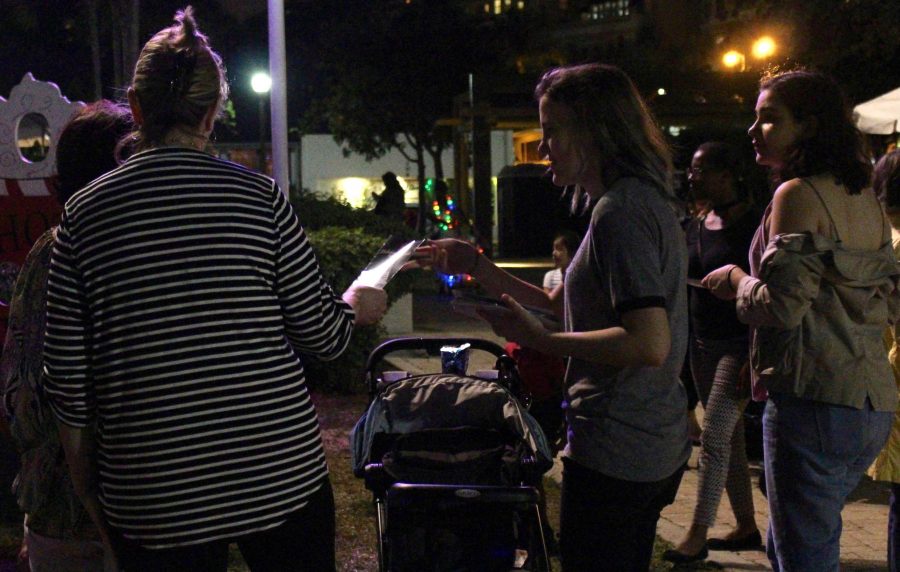 (L-R) Communications juniors MLE DeJaco and Ruby Rosenthal pass out brochures while volunteering for National Honor Society during the Clematis by Night Tree Lighting on Dec. 1.
