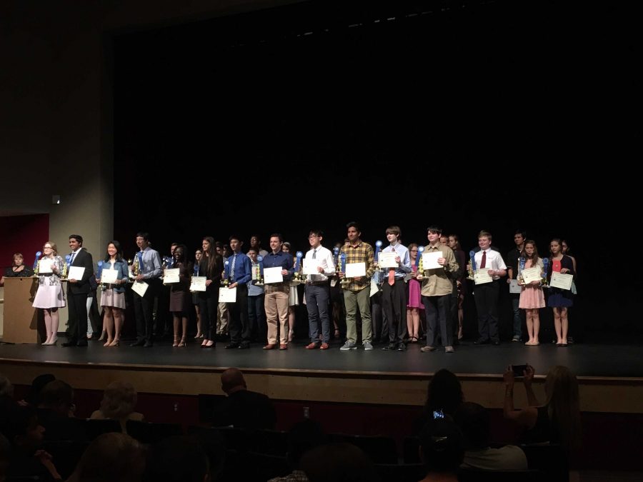 Holding+his+award+strings+junior+Ray+Jia+poses+for+a+picture+with+other+award+recipients+at+the+science+fair.+