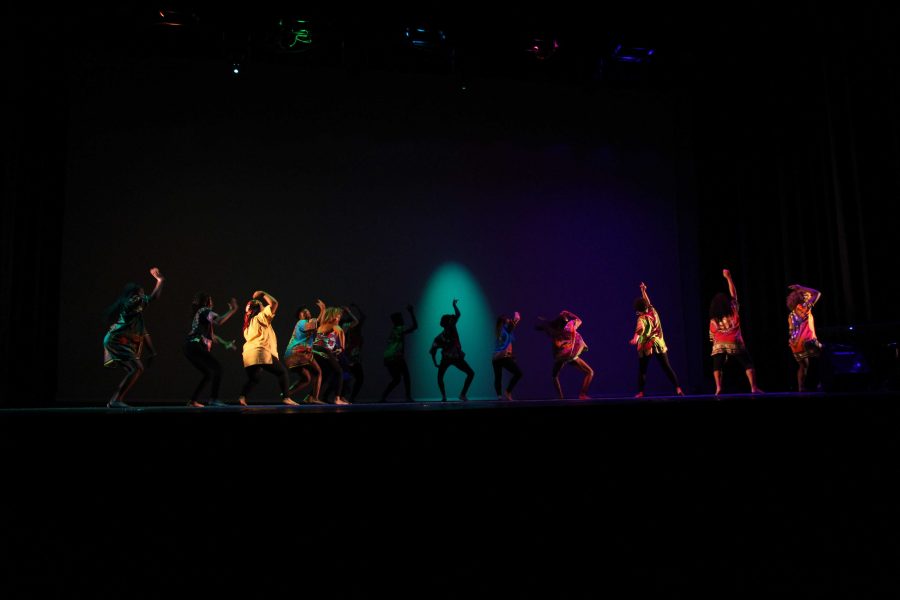 Students perform an African high-energy dance wearing clothes that represent their culture, and how it has developed through time. 
