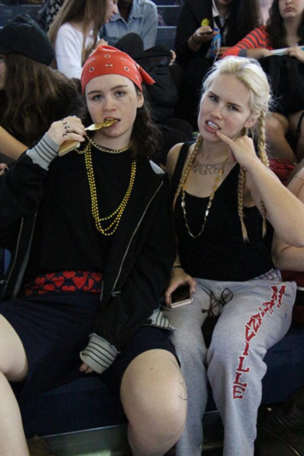 Visual senior Eloise Janssen Strings senior Arija Kuplins pose for rap/hip-hop day. White tank tops, sweat pants, fake tattoos, and other items stereotypical of the hip-hop community, and broader African-American community, were commonplace.