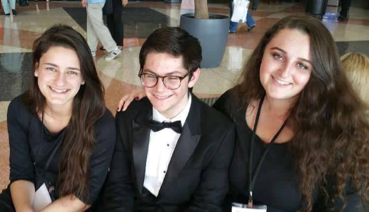 During the day of the Philharmonic orchestra performance, band junior Chloe Tordi (L-R), senior Harrison Cody, and junior Rachel Gebeloff dress in their performance attire for All-State.