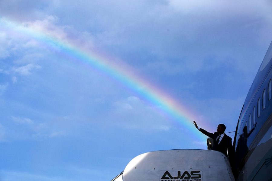 President Barack Obama gives a wave as he boards Air Force One prior to departure from Kingston, Jamaica on April 9, 2015. 