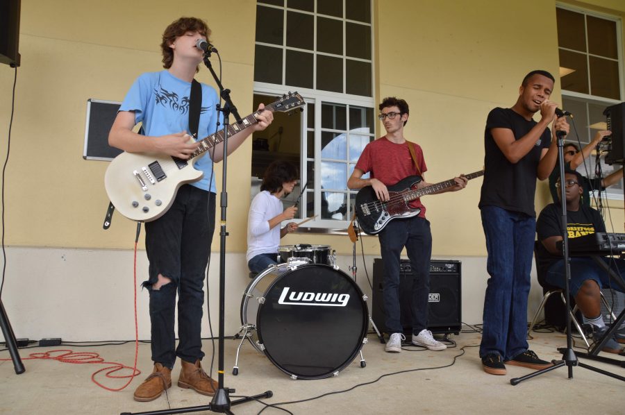 The collective members (L-R) theatre senior Benjamin Rothschild, sophomore Alex Shaw, senior David Mendelsohn, vocal junior Dylan Melville, and strings junior Allan Cadet performing outside the cafeteria during lunch on Friday, Feb. 10.