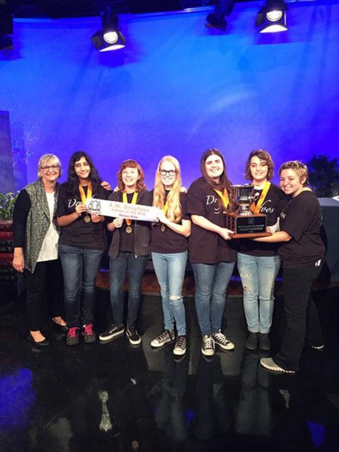 Media Center Specialist Cookie Davis (L-R), communications senior Uma Raja, communications senior Brianna Steidle, strings senior Emily Winters, communications senior Megan Horan, communications senior Samantha Marshall, and communications senior Kayla Kirschenbaum stand with their trophy after competing in Battle of the Books.