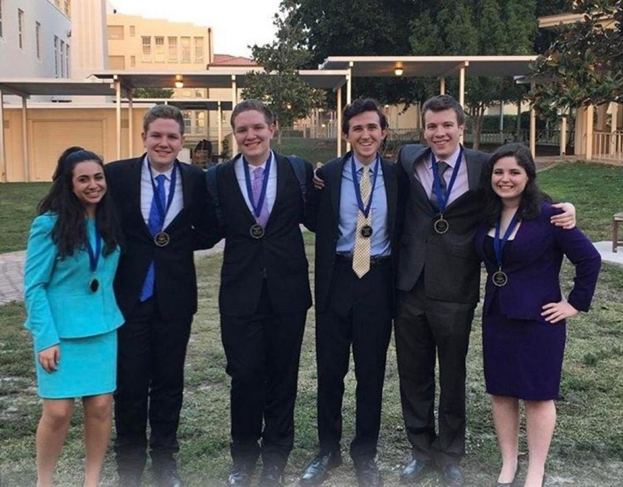 Communications freshmen Mara Vaknin (L-R), Kevin Ahern, Kyle Ahern, junior Alex Gordon, senior Jake Perl, and junior Maya Levkovitz. Students who qualified for the national tournament at Kentucky in May 2017 pose with their medals after the Palm Beach Catholic Forensic League (PBCFL) Grand Finals award ceremony. 