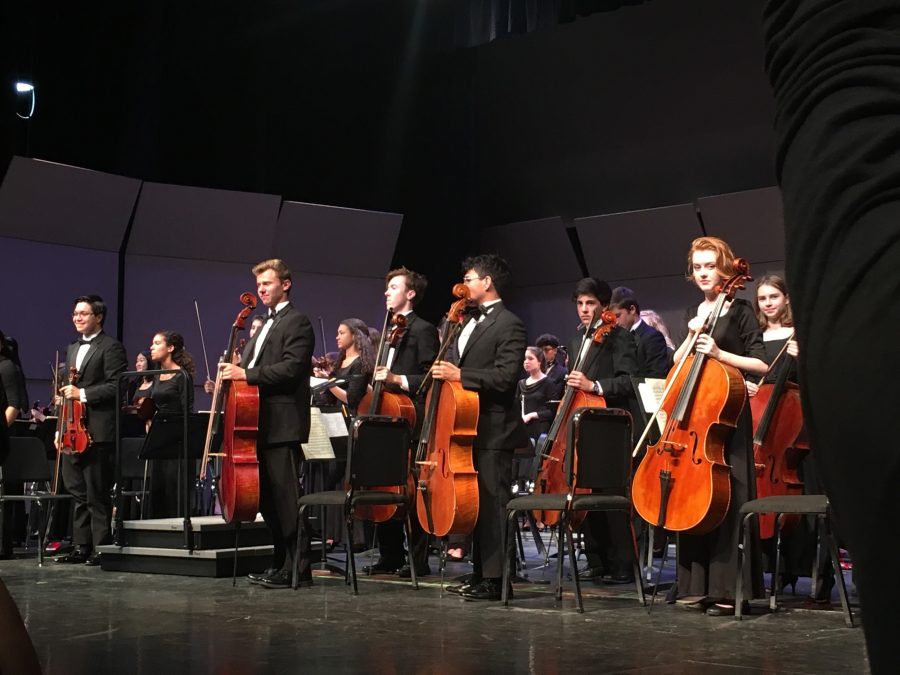 Following the last movement, students rise from their seats as they are given a standing ovation by the audience.