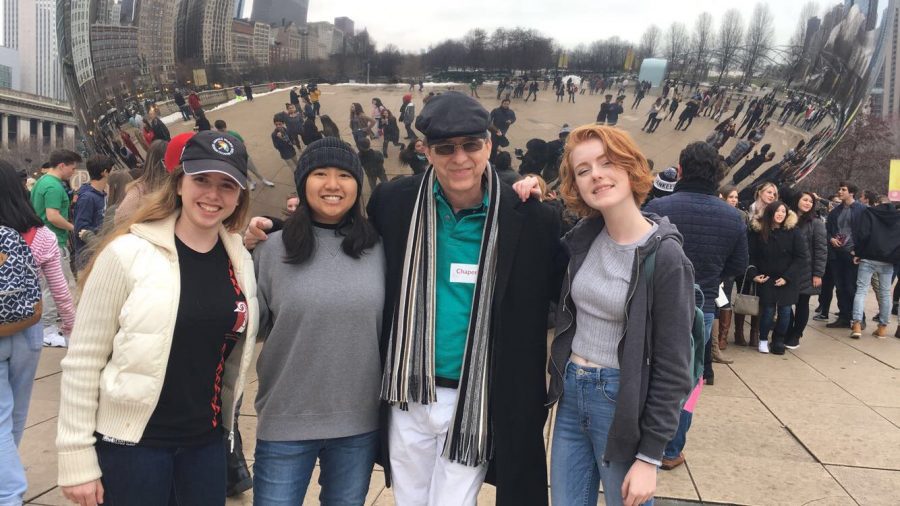 (L-R) Strings sophomore Hayley Huber, Miajoy Daorerk, strings director Wendell Simmons, and strings sophomore Leah Winters pose in front of The Bean at Chicago.