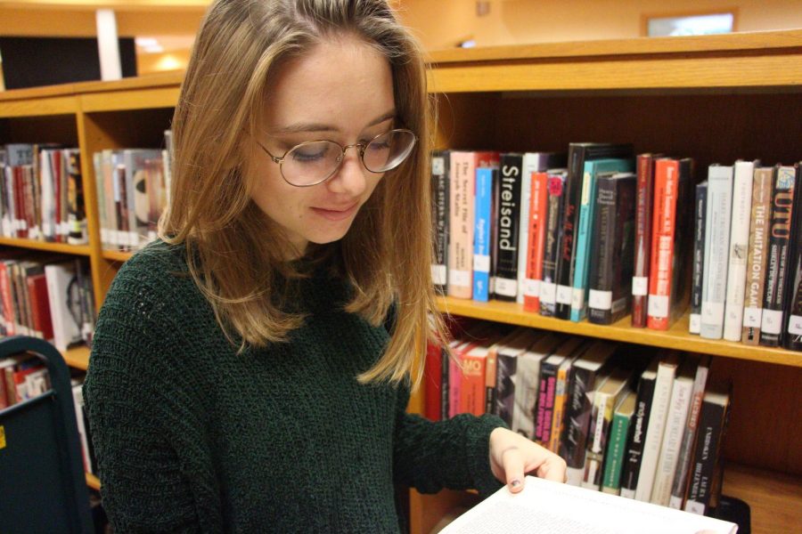 Digital junior, Grace Plett, enjoying a novel in the media center.